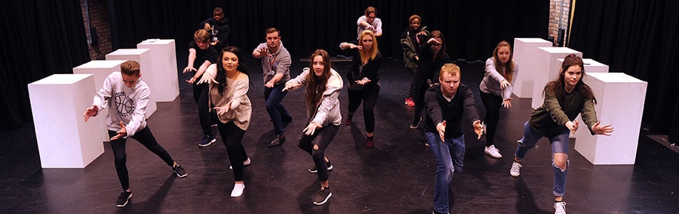a group of students pushing outwards